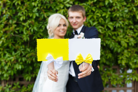 Bride and groom holding white and yellow plate in their handsの写真素材