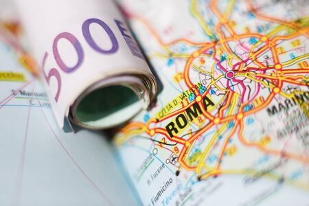 Euro banknotes on a geographical map of Roma, Italyの写真素材