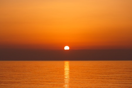 Sunrise over the sea at the summer timeの写真素材