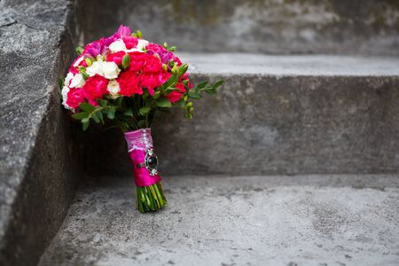 Bridal bouquet on a stone stairs outdoorの写真素材