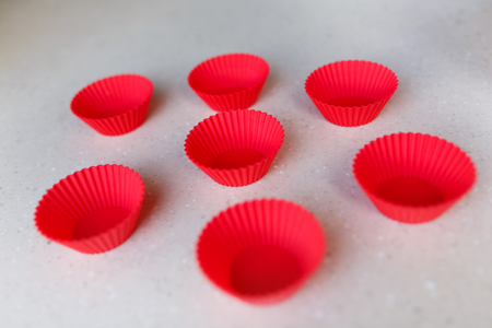 Red silicone cake pans on a tableの写真素材