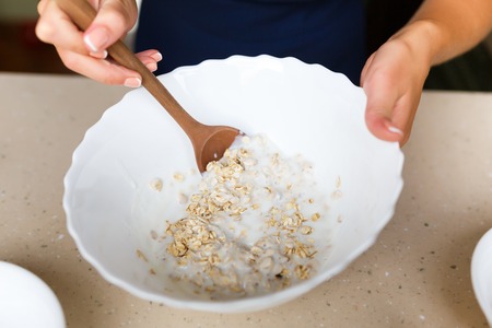 Young woman making a dough for dietary cakesの写真素材