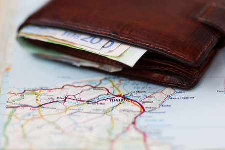 Euro banknotes inside wallet on a geographical map of Tunis, Tunisの写真素材