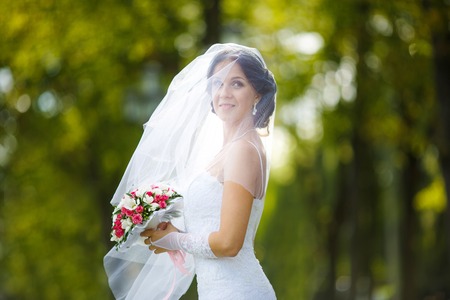 Portrait of a bride covered with veil on her wedding dayの写真素材