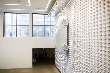 Munich, Germany - January 03 2016: White cars on the wall in exhibition of Pinakothek der Moderne museum, situated in the city centre of Munichのeditorial素材