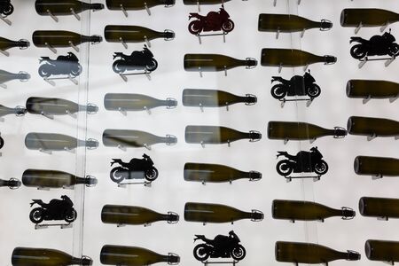 Silhouettes of bottle and motobikes on the wall in cafe