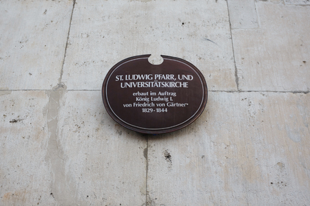 Sign on the wall of the Catholic Parish and University Church St. Louis, the church in neo-romanesque style in center of Munichの写真素材