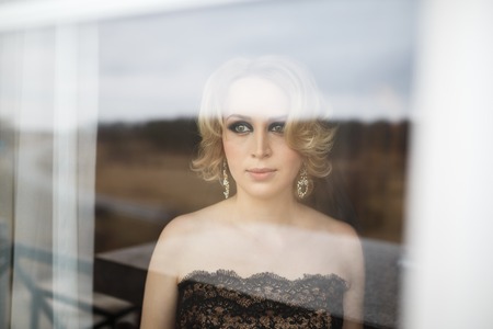 Portrait of the bride through a windowの写真素材