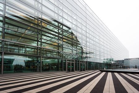 Munich, Germany - January 08 2016: Modern glass facade of Munich airport with striped terrace on the foregroundのeditorial素材