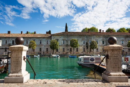 Peschiera del Garda, Italy - May 03 2016: Old gate to the marina in canal of old townのeditorial素材