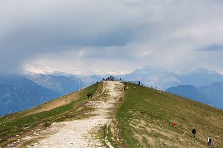 Monte Baldo, Italy - May 03 2016: Tourists walking on the mount of Monte Baldo