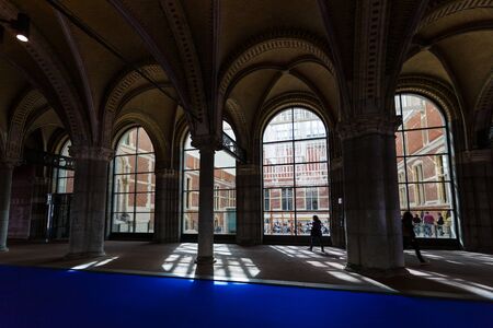 Amsterdam, Netherlands - July 02 2016: Silhouette of people in the corridor of Rijksmuseum, the art...