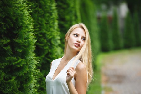 Portrait of adorable blonde woman outdoor, summer timeの写真素材