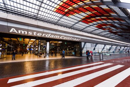 Amsterdam, Netherlands - July 01 2016: Some people expect transport in the railway station, rainy weatherのeditorial素材