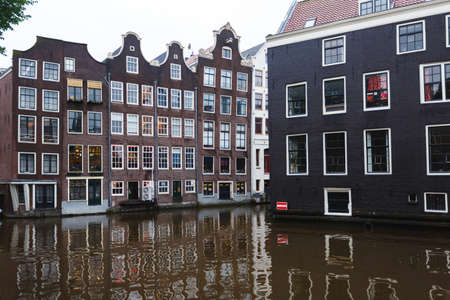 Amsterdam, Netherlands - July 01 2016: View of the traditional Dutch houses with reflection in waterのeditorial素材