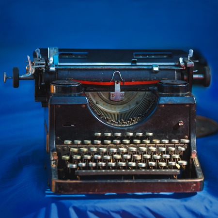 Vintage typewriter on the blue background, close upの写真素材
