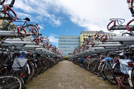 Zaandam, Netherlands - July 02 2016: Bicycle parking on the background of the traditional dutch buildings, summer timeのeditorial素材