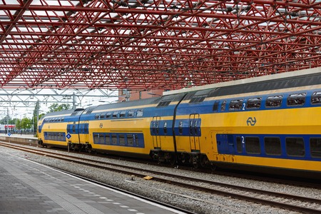 Zaandam, Netherlands - July 02 2016: The moving train on the background of the urban landscape in...