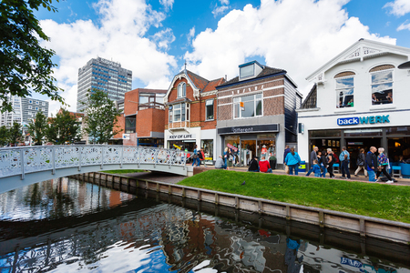 Zaandam, Netherlands - July 02 2016: Some people are walking on a central street, build up with traditional Dutch housesのeditorial素材