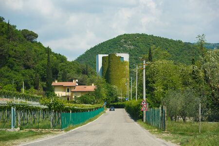 Molina, Italy - May 07 2016: Industrial building overgrown with ivy on the way to the small resort town of Molinaのeditorial素材
