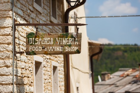 Molina, Italy - May 07 2016: The pointer to the wine store in the small Italian town of Molina
