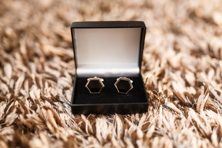 The cufflinks in a box on a wool surfaceの写真素材