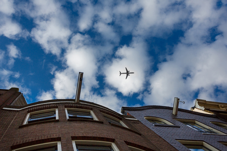 The airplane over the traditional Dutch houses, Amsterdamの写真素材