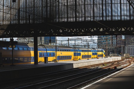 Amsterdam, Netherlands - July 02 2016: The passenger train into Amsterdam Central Railroad Stationのeditorial素材