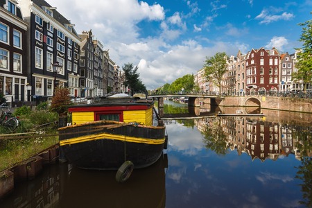 Amsterdam, Netherlands - July 03 2016: The traditional Dutch houses reflected in water on Singel street, sunny morningのeditorial素材
