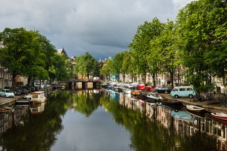 Amsterdam, Netherlands - July 03 2016: The traditional Dutch houses reflected in water on Singel street, sunny morningのeditorial素材