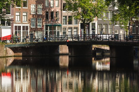 Amsterdam, Netherlands - July 03 2016: The traditional Dutch houses reflected in water on Singel street, sunny morningのeditorial素材