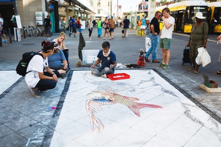 Berlin, Germany, August 27 2016: Street artist paints a picture on the asphalt near Alexanderplatz, summer timeのeditorial素材