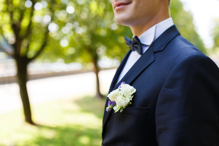 Happy young groom in a park in summerの写真素材