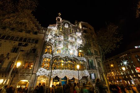 Barcelona, Spain - January 03 2017: Some people are walking near the decorated facade of House of Batllo at nightのeditorial素材