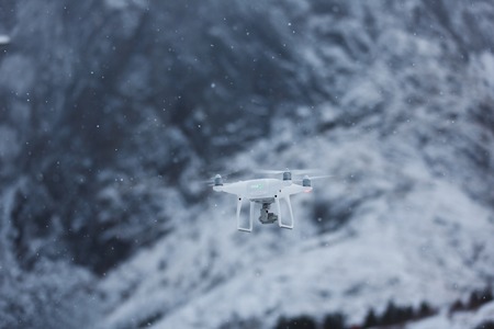 The drone is flying in winter mountainの写真素材
