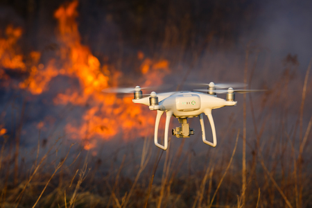 The drone flies against the background of a spring forest fireの写真素材
