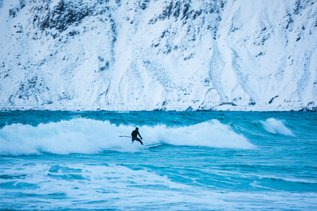 Flakstad, Norway - March 18 2017: Surfer are training on the Skagsanden beach of the Lofoten Islands
