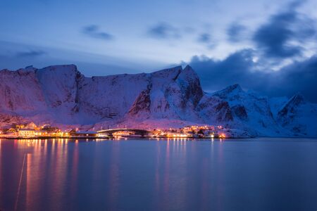Snowy fishing village in the Lofoten islands at nightの写真素材