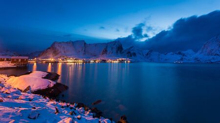 Snowy fishing village in the Lofoten islands at nightの写真素材
