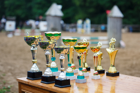 Elblag, Poland - June 25 2017: Sports cups on the table against the background of the arena during the amateur competition of Piastowiada 2017のeditorial素材