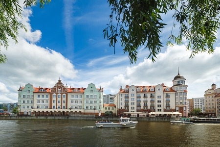 Kaliningrad, Russia - July 14 2017: Buildings of the Fishing Village on the riverside in summer