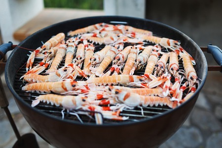 Fresh langoustines is preparing on grill outdoorsの写真素材