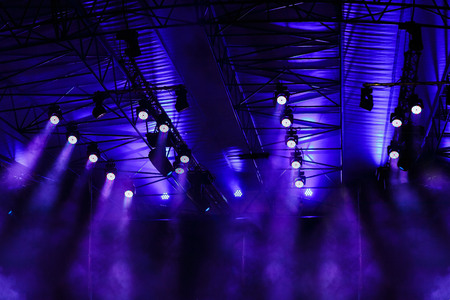 Blue lights on the ceiling of a stageの写真素材