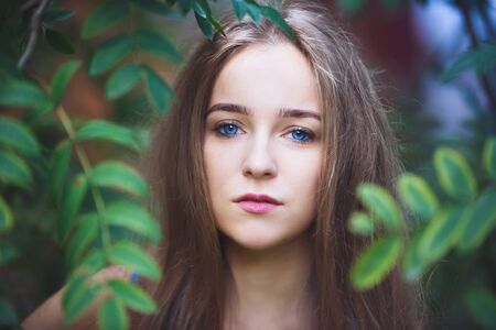 Close-up portrait of the young girl in a forestの写真素材