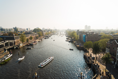 Tourist ships in canal of Amsterdam, aerial viewの写真素材