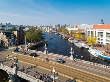 Amsterdam, Netherlands - September 24 2017: Some tourists are walking on the bridge against the background of the Dutch National Opera and Ballet, aerial viewのeditorial素材