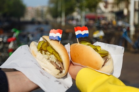 Traditional dutch sandwich with herring in a hands outdoorsの写真素材