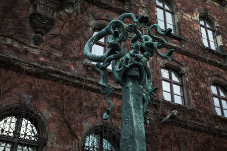 Wroclaw, Poland - January 06 2018: Statue of Gorgona's head against the background of the National Museum of Wroclaw at eveningのeditorial素材