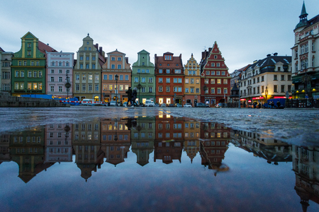 Wroclaw, Poland - January 03 2018: Colorful houses are reflected in the puddle on the Market Square of Wroclaw at eveningのeditorial素材