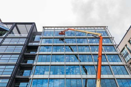 Washing windows on a high-rise building using a high-lift platform